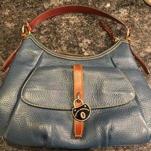 Dooney & Bourke purse. Used. Blue with brown trim and red interior.